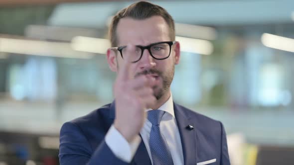 Portrait of Angry Middle Aged Businessman Arguing Shouting