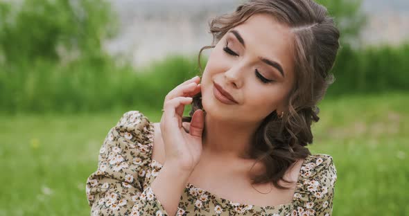 Young Woman in Summer Outdoors Spend Time Around Fresh Green Trees