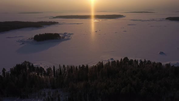 Frozen Kandalaksha Bay and Tree Islands on Winter Sunny Day