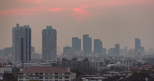 Skyscrapers in Bangkok city, Thailand. Day to night, timelapse. The sky changing color from pink to