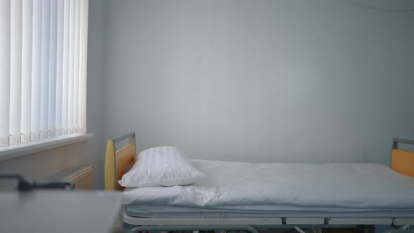 Panning Shot of Clean White Hospital Bed in Modern Medical Clinic Indoors