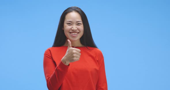 Young Woman Giving Thumbs Up