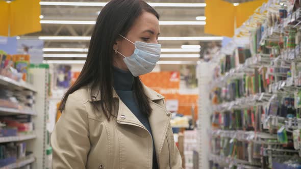 Young Woman in Medical Mask Selects Food in Supermarket, Protection Coronavirus Pandemic Covid-19 in