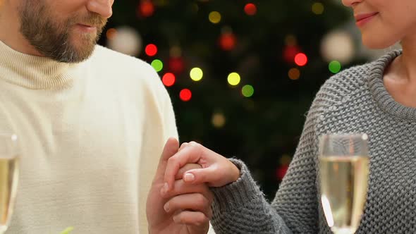 Man Tenderly Kissing Woman Hand, Romantic Date on Christmas Night, Closeup