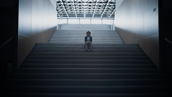 Stressed Schoolboy Stay Alone on Stairway Close Up