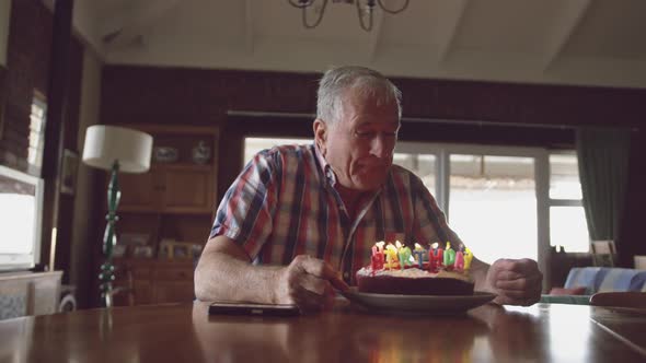 Senior man with a birthday cake at home