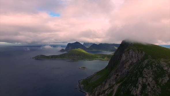 Flying in clouds by the cliffs on Lofoten islands, Norway