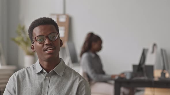 African-American Programmer Talking at Camera