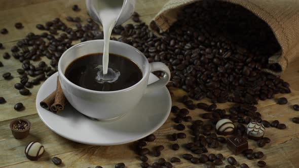 Milk Cream Poured Into Black Coffee