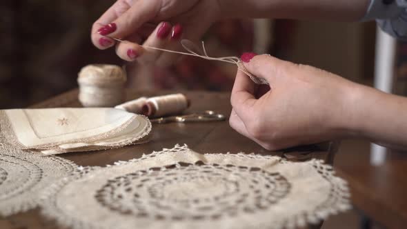  The embroiderer at work․ Female hands with needle.