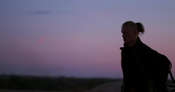 A Man with a Flamethrower at Sunset in Slow Motion