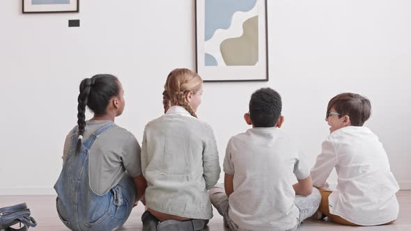 Kids Sitting on Floor of Art Gallery