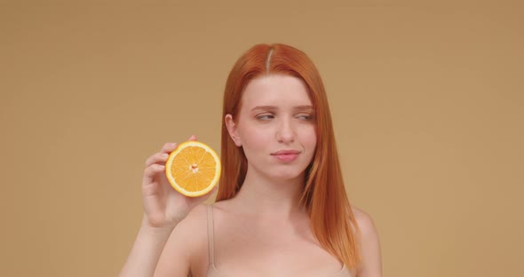 Young Woman Shows Organic Products and Smooth Face Grimacing