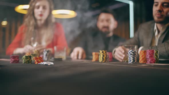 A Holdem Dealer is Distributing of Cards in a Casino