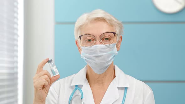 Senior lady doctor with glasses and disposable mask