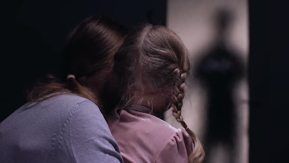 Scared Woman Hugging Child, Afraid of Cruel Criminal Silhouette Entering Room