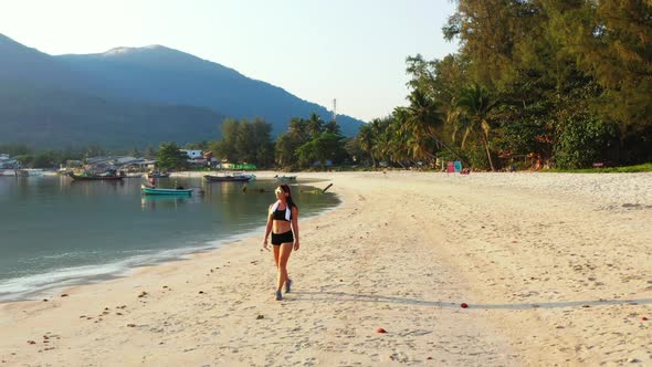 Tourists posing on tropical island beach time by blue sea and white sand background of Koh Phangan n