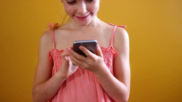 Schoolgirl using mobile phone in classroom