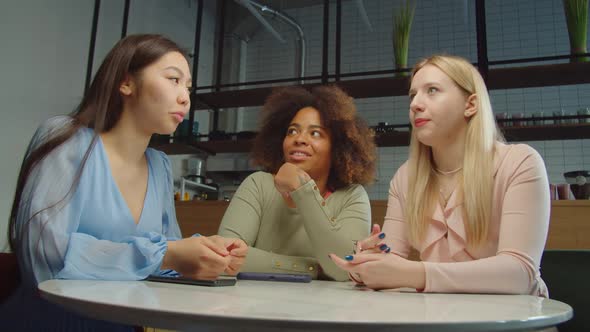 Pretty Woman Talking Latest News to Diverse Female Friends