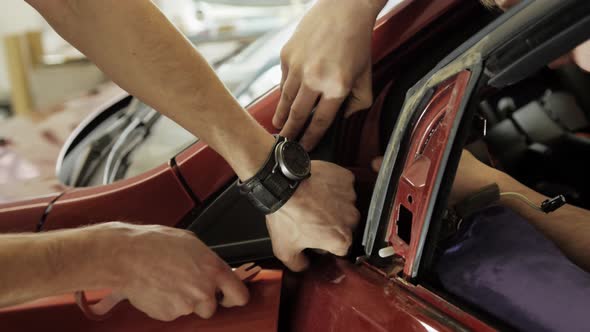 Hands of Car Mechanic in Auto Repair Garage Service