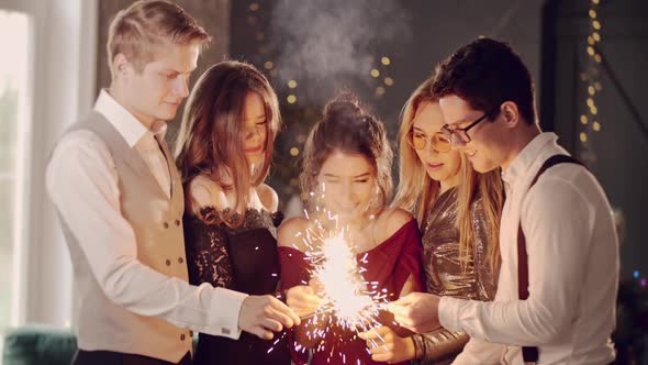 Asian Girl and Group Young College Student Friends Lit Light Sparkler in Hand Fireworks Sing and