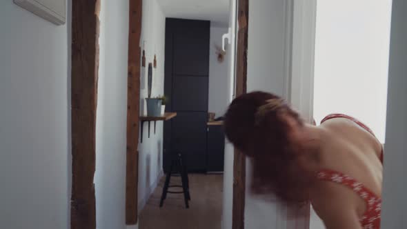 Woman in swimming suit walking in corridor