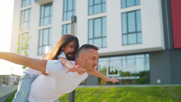 Loving Dad Play Piggybacking Daughter