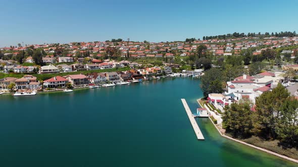 Aerial drone flying into houses in a cove on community lake mission viejo camera 2