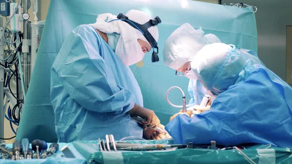 Group of Surgeons are Performing an Operation Behind a Curtain