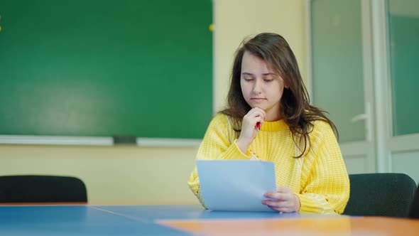 Beautiful schoolgirl in the classroom