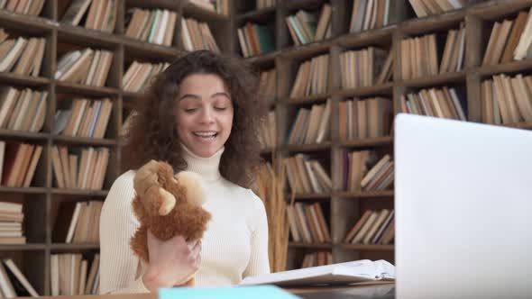 Young Hispanic Female Teacher Reading Fairy Tale Book Teaching Children in Zoom