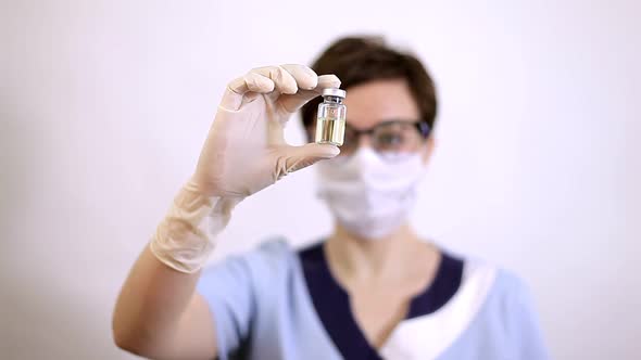 A Doctor or Nurse in Nitrile Gloves Holds in His Hand a Vaccine Vaccinated Against Influenza