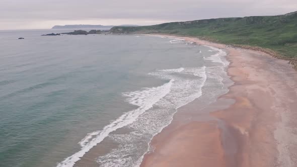 Stunning sandy beach, Antrim Coast of Northern Ireland. Aerial drone view