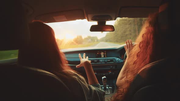 Two Happy Female Woman Friends Enjoy Travel in Car