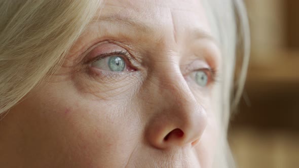 The Face and Eyes of the Old Woman. Large Wrinkles on the Old Woman's Face. Face Close Up