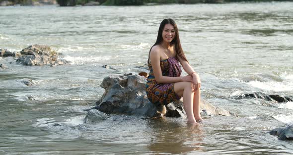 Asian Girl Wearing Sarong And Smiling In River