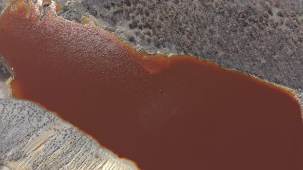 Red acidic water from a mining site from above 4K drone video