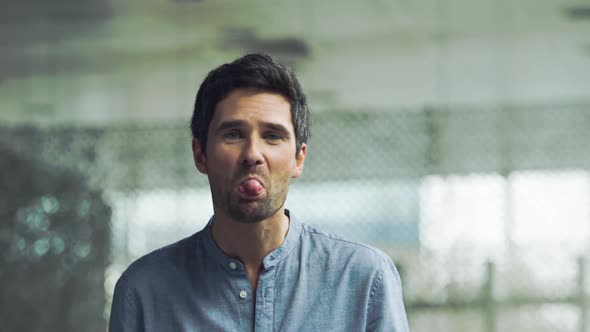 Man sticking out tongue at camera