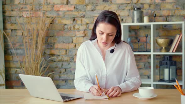 Confident Smiling Businesswoman Having a Video Conversation in Office