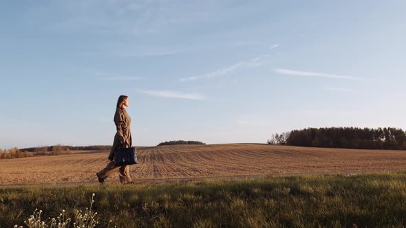 Road To Success. Elegant Businesswoman Is Walking on the Road at Nature Landscape Background. Summer