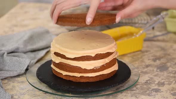 Girl making a caramel cake in a bakery
