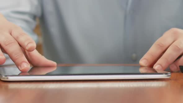 Close up Of Male Hands Scrolling on Tablet, Viewing Photos in Social Media