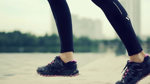 Runner Woman Runs In Park. Legs Jogging In Sport Shoes. Fitness Girl Running Exercise. Run On Sand.