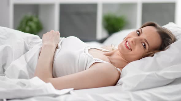 Attractive Young Feminine Resting on Comfy Bed Enjoy Morning