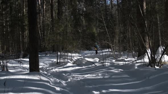 A Miniature Girl on Skis Emerges From the Depths of the Forest