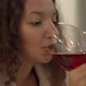 Young Woman with Long Loose Curly Hair Tastes Red Wine - VideoHive Item for Sale