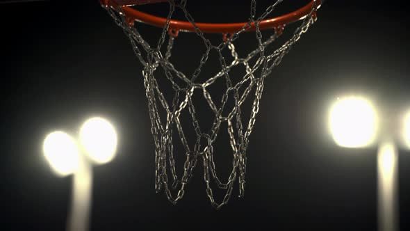 Basketball basket with iron nets in floodlight. Basketball Court. Team play. Tense moment