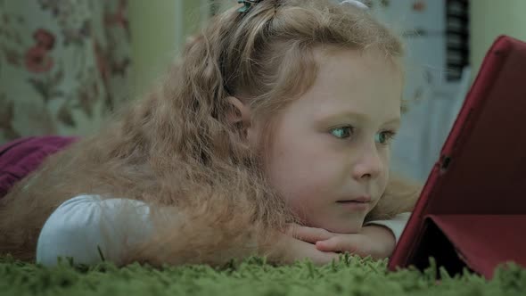 Girl Preschooler Uses a Computer Tablet