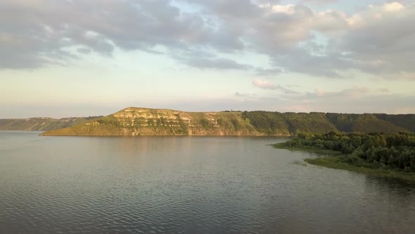 Aerial view of wide Dnister river and distant rocky hills in Bakota area, part of the National park 