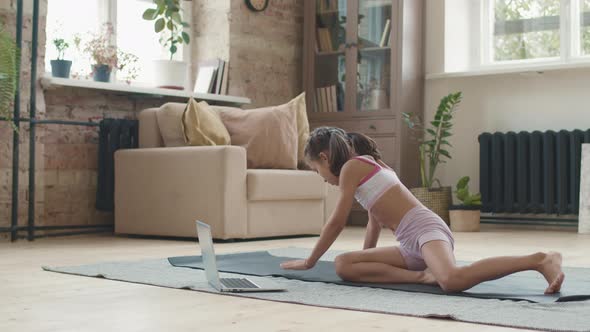 Little Girl Stretching on Yoga Mat